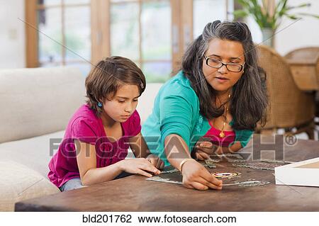 Mother and daughter putting puzzle together View Large Photo Image Stock Image - Mother and daughter putting puzzle together. Fotosearch