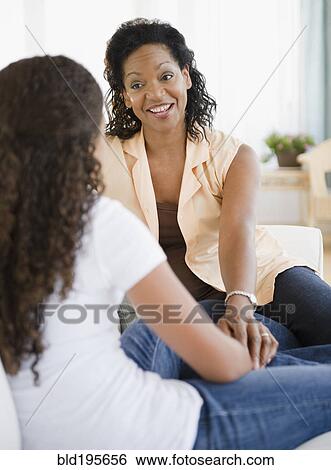 Mother and daughter talking together View Large Photo Image Stock Photograph - Mother and daughter talking together. Fotosearch