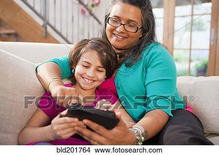 Mother and daughter using digital tablet View Large Photo Image Picture - Mother and daughter using digital tablet. Fotosearch