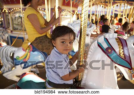 Picture - Mother and son on merry-go-round. Fotosearch