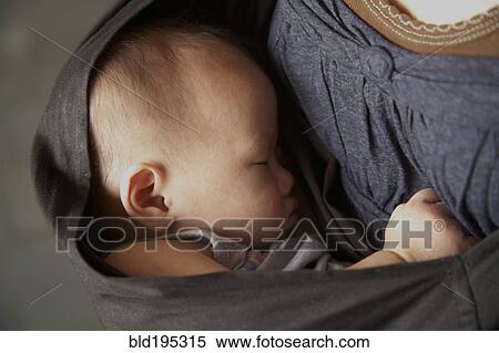 Mother carrying baby in sling View Large Photo Image Stock Photography - Mother carrying baby in sling. Fotosearch