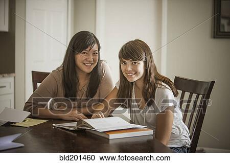 Mother helping daughter with homework View Large Photo Image Stock Image - Mother helping daughter with homework. Fotosearch