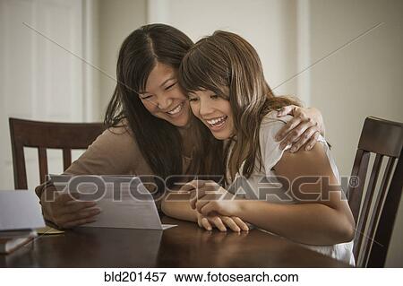 Stock Photo - Mother helping daughter with homework. Fotosearch
