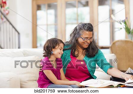 Stock Photo - Mother helping daughter with homework. Fotosearch