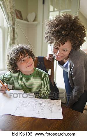Mother helping son with homework View Large Photo Image Stock Image - Mother helping son with homework. Fotosearch