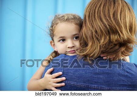 Stock Photo - Mother holding and comforting daughter. Fotosearch