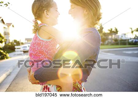 Mother holding daughter in street View Large Photo Image Stock Photography - Mother holding daughter in street. Fotosearch