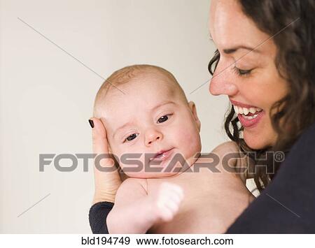 Stock Photo - Mother holding newborn baby. Fotosearch