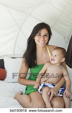 Mother holding son on lap View Large Photo Image Stock Photo - Mother holding son on lap. Fotosearch