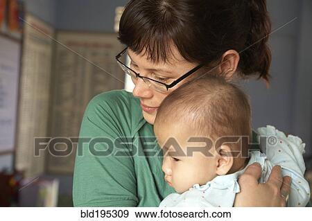 Stock Photo - Mother hugging baby. Fotosearch