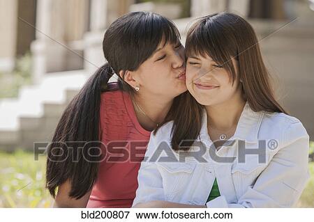 Stock Photo - Mother kissing daughter. Fotosearch