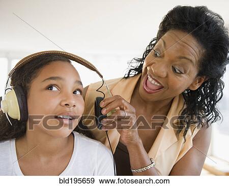 Mother shouting at daughter listening to headphones View Large Photo Image Stock Photo - Mother shouting at daughter listening to headphones. Fotosearch
