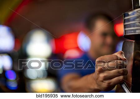 Native American man pulling lever of slot machine in casino View Large Photo Image Stock Photography - Native American man pulling lever of slot machine in casino. Fotosearch