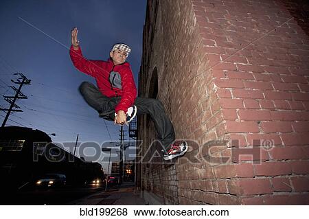 Stock Photo - Pacific Islander man breakdancing in urban area. Fotosearch