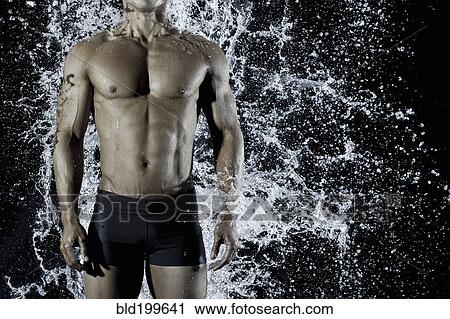 Stock Image - Pacific Islander man getting splashed with water. Fotosearch
