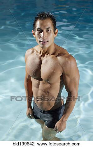Pacific Islander man standing in swimming pool View Large Photo Image Stock Image - Pacific Islander man standing in swimming pool. Fotosearch