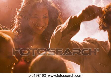 Stock Image - People dancing in nightclub. Fotosearch
