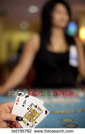 Stock Image - People playing poker in casino. Fotosearch