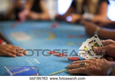 Stock Image - People playing poker in casino. Fotosearch