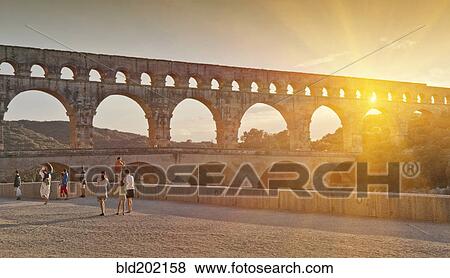 People sightseeing near aqueduct View Large Photo Image Stock Photo - People sightseeing near aqueduct. Fotosearch