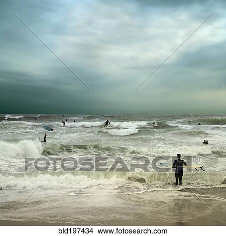 People surfing in stormy ocean View Large Photo Image Picture - People surfing in stormy ocean. Fotosearch