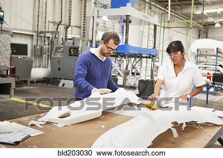 Stock Image - People working in manufacturing plant. Fotosearch