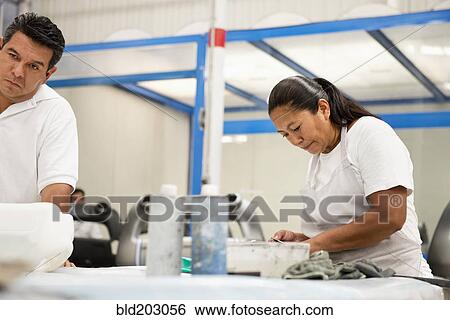 Stock Photograph - People working in manufacturing plant. Fotosearch