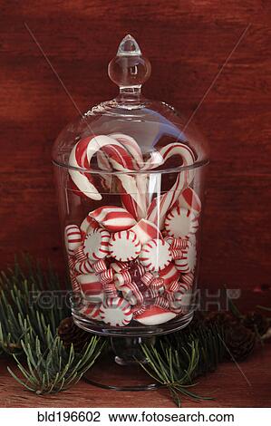 Stock Image - Peppermint candies in glass jar. Fotosearch