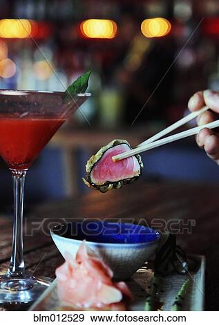 Person eating tuna sushi in restaurant View Large Photo Image Stock Photo - Person eating tuna sushi in restaurant. Fotosearch