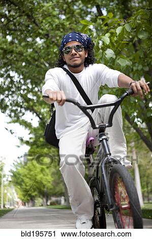 Peruvian man riding bicycle on sidewalk View Large Photo Image Stock Image - Peruvian man riding bicycle on sidewalk. Fotosearch