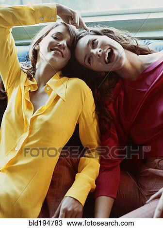 Stock Image - Playful Caucasian women sitting. Fotosearch