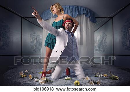 Stock Photo - Playful couple on round bed. Fotosearch