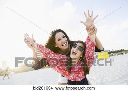 Picture - Playful Hispanic mother and daughter. Fotosearch