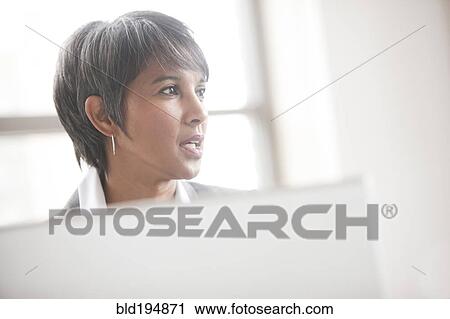 Stock Image - Portrait of mixed race businesswoman. Fotosearch