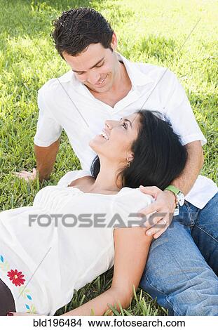 Pregnant woman laying in husband's lap View Large Photo Image Picture - Pregnant woman laying in husband's lap. Fotosearch