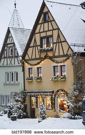 Stock Photo - Quaint, snow covered village decorated for Christmas. Fotosearch