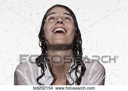 Picture - Rain falling on Caucasian businesswoman. Fotosearch