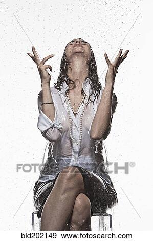Rain falling on Caucasian businesswoman View Large Photo Image Stock Photo - Rain falling on Caucasian businesswoman. Fotosearch