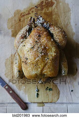 Stock Image - Roast chicken on cutting board. Fotosearch