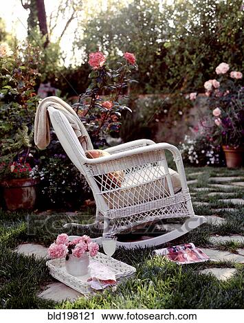 Rocking chair and drinks in blooming garden View Large Photo Image Stock Image - Rocking chair and drinks in blooming garden. Fotosearch