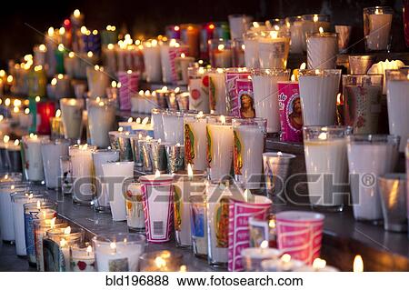 Rows of burning religious candles View Large Photo Image Stock Photo - Rows of burning religious candles. Fotosearch