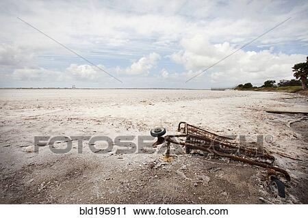 Rusted shopping cart buried in sand View Large Photo Image Stock Image - Rusted shopping cart buried in sand. Fotosearch