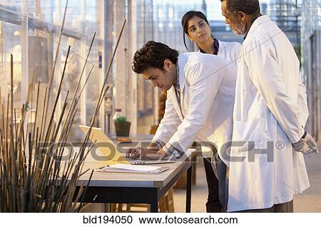 Stock Image - Scientists working in laboratory. Fotosearch