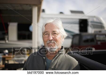 Senior Caucasian man sitting outside motor home View Large Photo Image Stock Image - Senior Caucasian man sitting outside motor home. Fotosearch