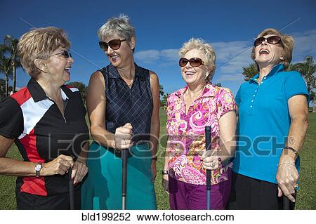 Stock Image - Senior Caucasian women playing golf. Fotosearch