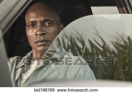 Serious African American man in car View Large Photo Image Stock Photo - Serious African American man in car. Fotosearch