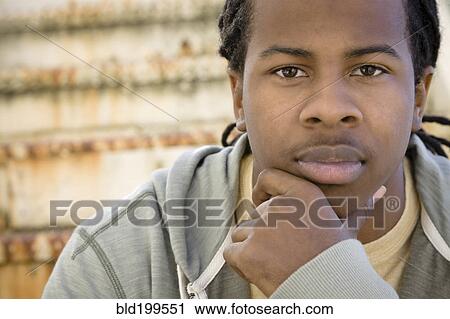 Stock Image - Serious Black man with hand on chin. Fotosearch