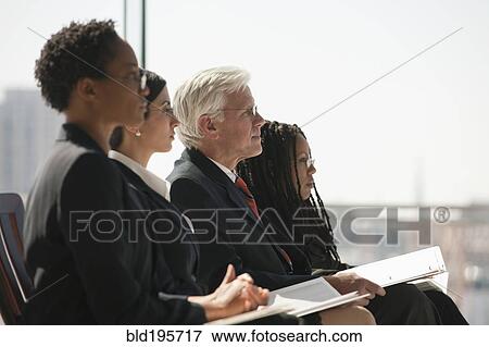 Stock Photo - Serious business people listening in meeting. Fotosearch