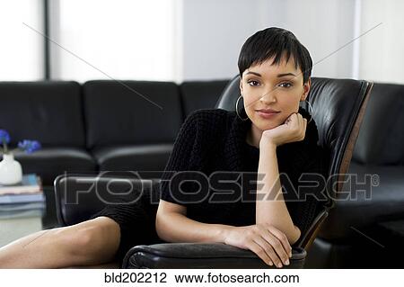 Serious businesswoman sitting in chair View Large Photo Image Stock Image - Serious businesswoman sitting in chair. Fotosearch