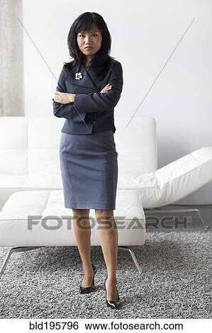 Stock Photograph - Serious businesswoman with arms crossed. Fotosearch